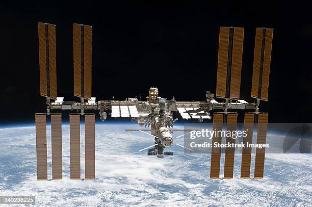 march 7, 2011 - the international space station in orbit above earth. - estação espacial internacional - fotografias e filmes do acervo