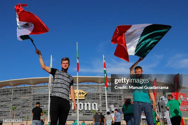 Fans of of Mexico wave Mexican flags outside the stadium prior the match between Mexico and Suriname as part of the CONCACAF Nations League at Corona...