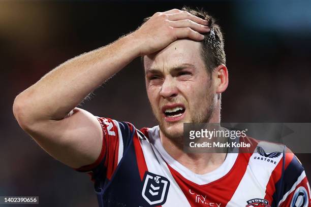 Luke Keary of the Roosters holds his head as he leaves the field for an Head Injury Assessment during the round 14 NRL match between the Sydney...