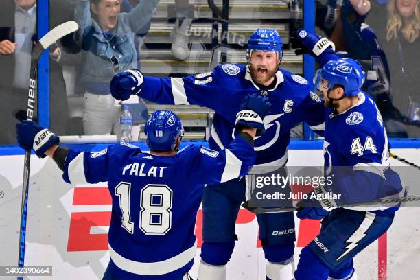 Steven Stamkos of the Tampa Bay Lightning celebrates with teammates Jan Rutta and Ondrej Palat after scoring a goal on Igor Shesterkin of the New...