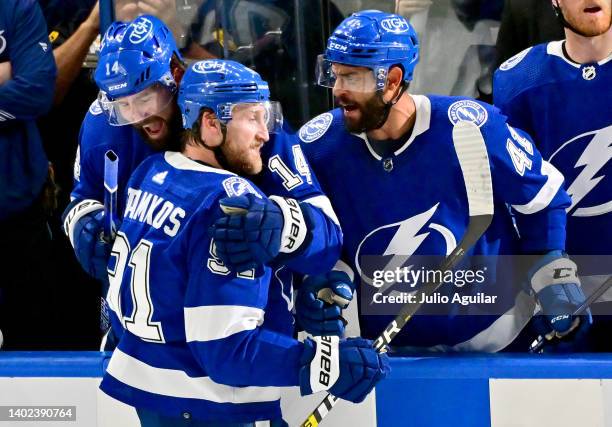 Steven Stamkos of the Tampa Bay Lightning celebrates with teammates Pat Maroon and Pierre-Edouard Bellemare after scoring a goal on Igor Shesterkin...