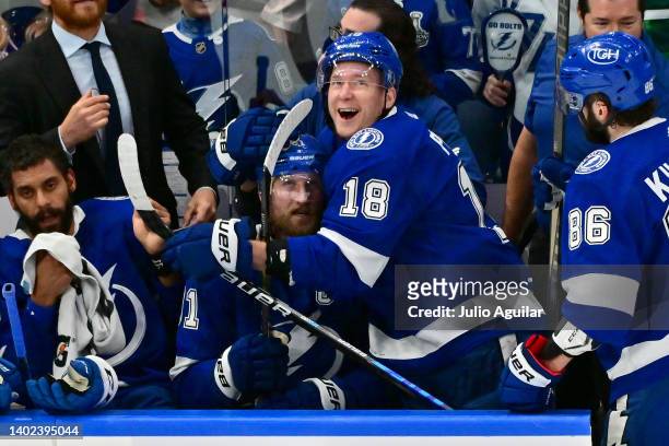 Steven Stamkos of the Tampa Bay Lightning celebrates on the bench with teammate Ondrej Palat after scoring a goal on Igor Shesterkin of the New York...