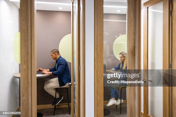 business people working in private cubicles at a coworking office - ostördhet bildbanksfoton och bilder