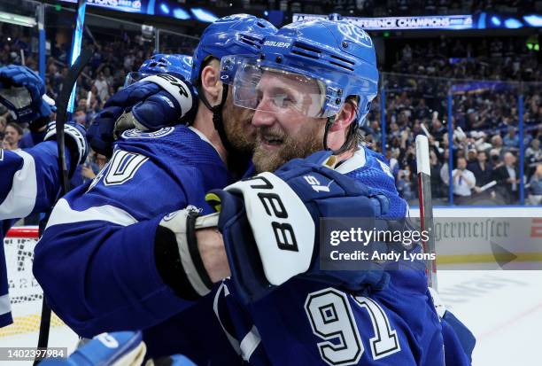 Corey Perry and Steven Stamkos of the Tampa Bay Lightning celebrate after defeating the New York Rangers with a score of 2 to 1 in Game Six to win...