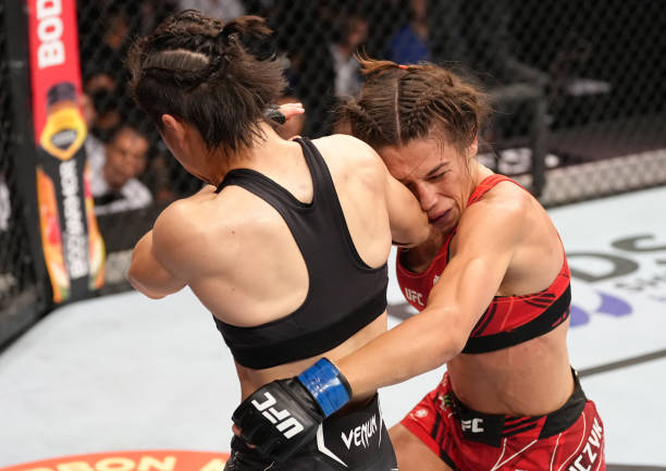 Zhang Weili of China knocks out Joanna Jedrzejczyk of Poland with a spinning back fist in a flyweight fight during the UFC 275 event at Singapore...