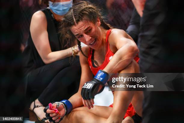 Joanna Jedrzejcyk of Poland reacts to losing to Zhang Weili of China during their Women's Strawweight Fight at Singapore Indoor Stadium on June 12,...