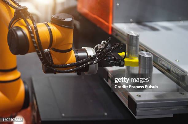 robot arm 's going to pick parts to cnc machine - cnc stock pictures, royalty-free photos & images