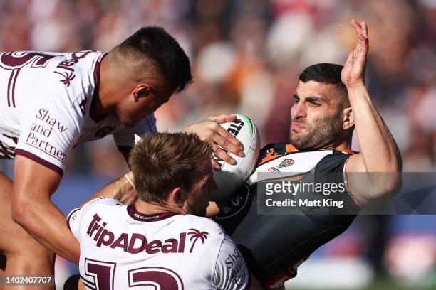 Alex Twal of the Tigers is tackled during the round 14 NRL match between the Wests Tigers and the Manly Sea Eagles at Campbelltown Stadium, on June...