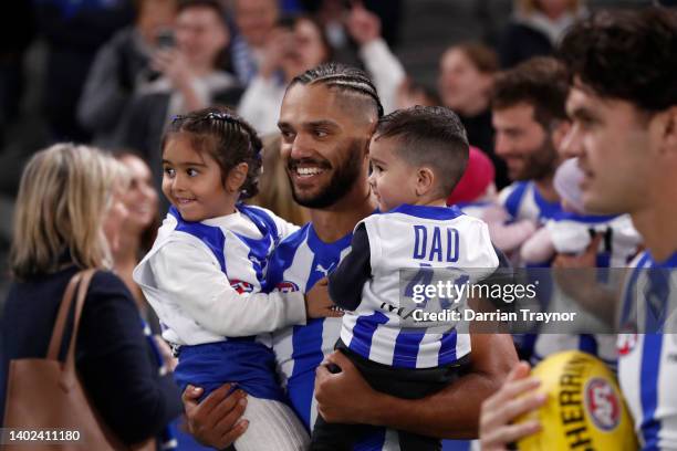 Aaron Hall of the Kangaroos runs out with his children before playing his 150th gameduring the round 13 AFL match between the North Melbourne...