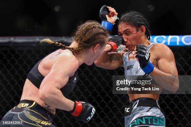 Valentina Shevchenko of Kyrgyzstan exchanges strikes with Taila Santos of Brazil during their Women's Flyweight Fight at Singapore Indoor Stadium on...