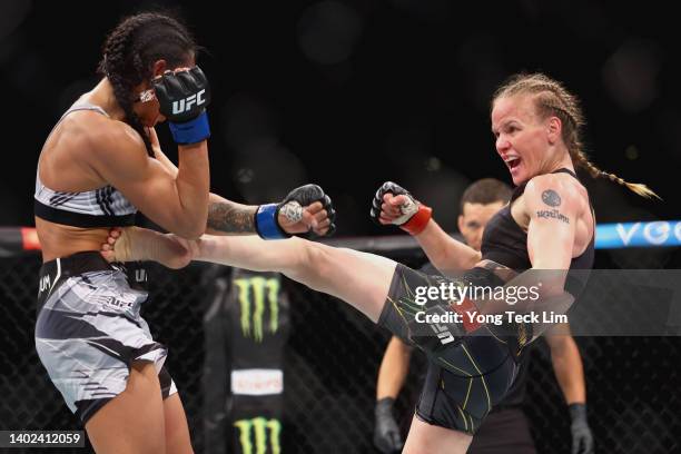 Valentina Shevchenko of Kyrgyzstan exchanges strikes with Taila Santos of Brazil during their Women's Flyweight Fight at Singapore Indoor Stadium on...