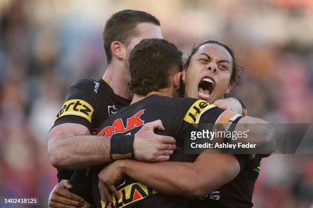 Nathan Cleary of the Panthers celebrates his try with Jarome Luai of the Panthers during the round 14 NRL match between the Newcastle Knights and the...