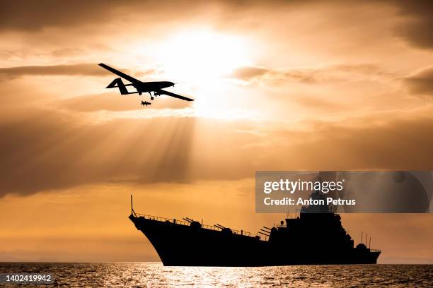 military unmanned aerial vehicle over a warship - veículo aéreo não tripulado - fotografias e filmes do acervo