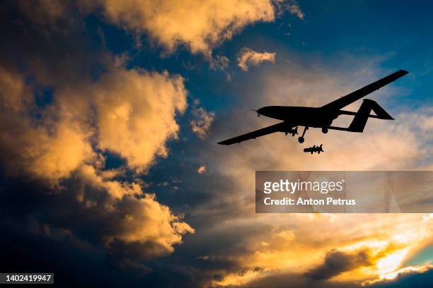military unmanned aerial vehicle at sunset. combat drone in military conflicts - terrorism concept stock pictures, royalty-free photos & images