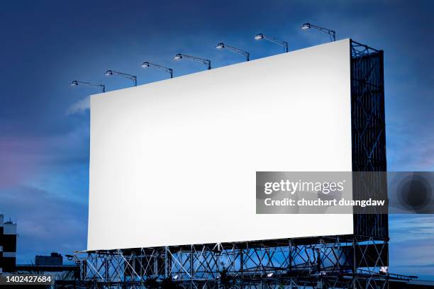 blank billboard with on road with city view background and blue sky background - poster mockup stock pictures, royalty-free photos & images