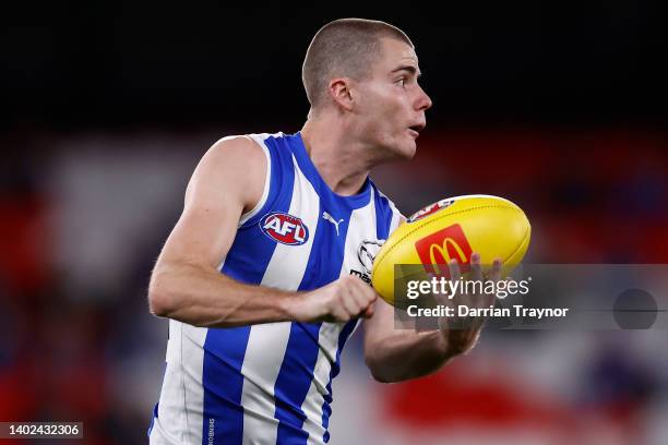 Jack Mahony of the Kangaroos handballs during the round 13 AFL match between the North Melbourne Kangaroos and the Greater Western Sydney Giants at...