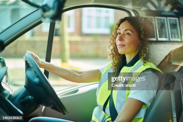 delivery driver driving - woman hi vis stock pictures, royalty-free photos & images