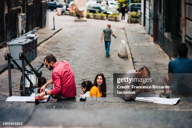 tourists eating pizza on the street of naples - italy city break stock pictures, royalty-free photos & images