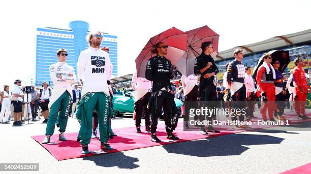 The drivers stand on the grid for the national anthem during the F1 Grand Prix of Azerbaijan at Baku City Circuit on June 12, 2022 in Baku,...