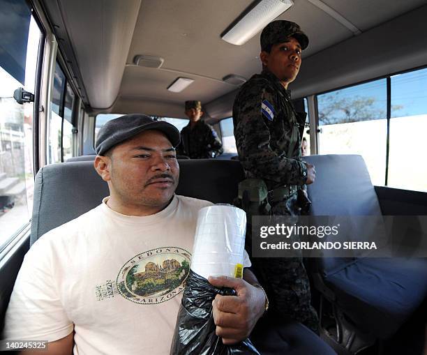 Soldiers of the Honduran Army armed with M-16 rifles provide security on public buses in Tegucigalpa on March 1, 2012. To combat the increasing...