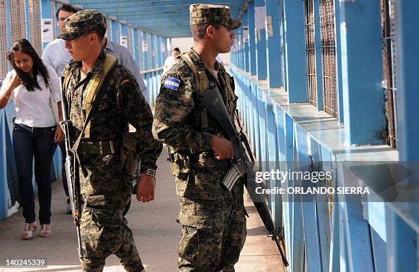 Soldiers of the Honduran Army armed with M-16 rifles provide security at a bus terminal in Tegucigalpa on March 1, 2012. To combat the increasing...