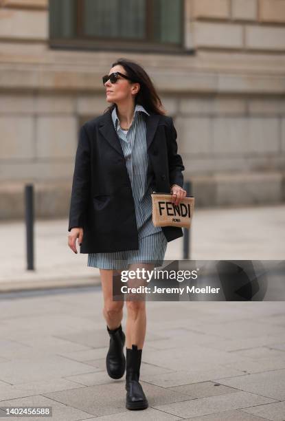 Elise Seitz seen wearing a brown Celine sunglasses, a blue/white striped two piece from Soho Studios, a dark grey blazer from Soho Studios, black...