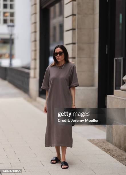 Elise Seitz seen wearing a brown Celine sunglasses, brown maxi dress from Soho Studios, black leather sandals from Ducie London, a black leather...