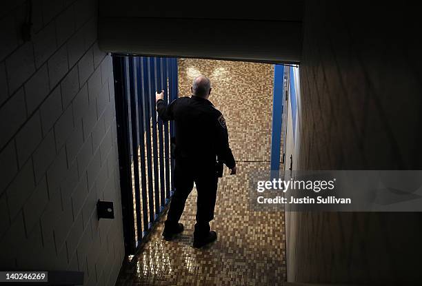 Police officer guards a hallway during a campaign rally for Republican presidential candidate, former Massachusetts Gov. Mitt Romney at Skyline High...