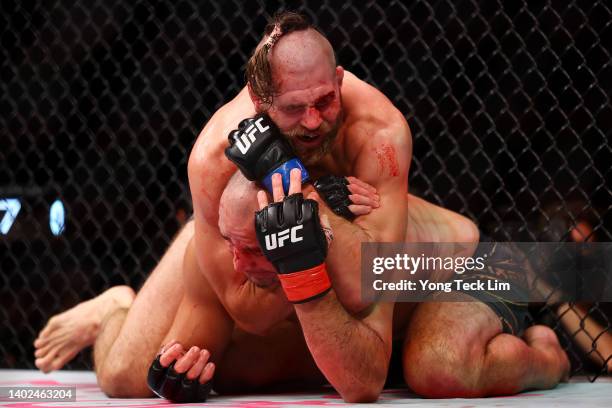 Jiri Prochazka of the Czech Republic submits Glover Teixeira of Brazil in the fifth round of their light heavyweight title bout during UFC 275 at...