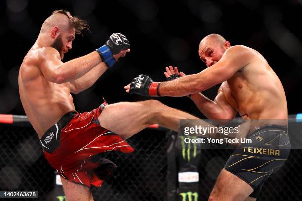 Jiri Prochazka of the Czech Republic kicks Glover Teixeira of Brazil in their light heavyweight title bout during UFC 275 at Singapore Indoor Stadium...