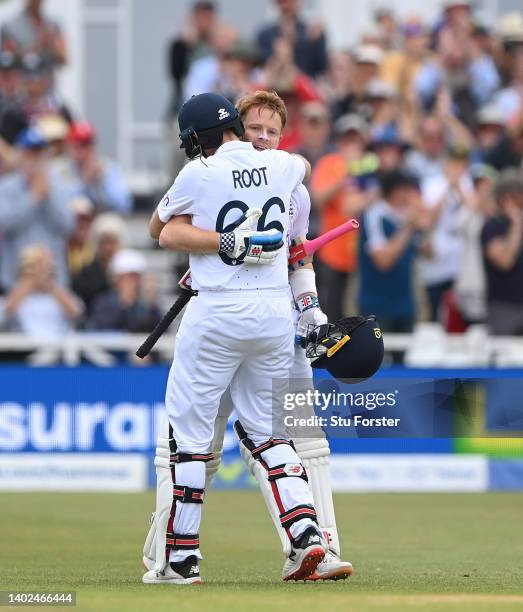 England batsman Ollie Pope celebrates his century with Joe Root during day three of the Second Test Match between England and New Zealand at Trent...