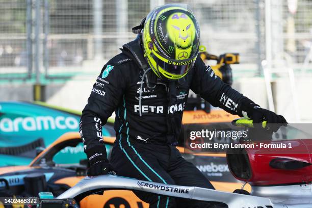 Fourth placed Lewis Hamilton of Great Britain and Mercedes climbs from his car after complaining of pain during the F1 Grand Prix of Azerbaijan at...