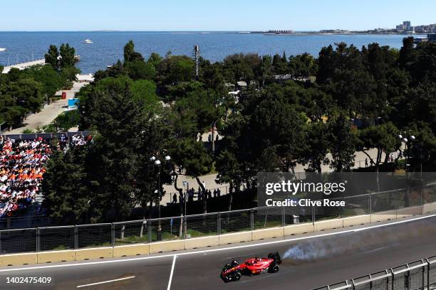 Smoke pours from the car of Charles Leclerc of Monaco driving the Ferrari F1-75 as his engine fails leading to him retiring from the race during the...