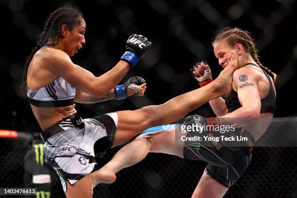 Taila Santos of Brazil kicks Valentina Shevchenko of Kyrgyzstan in their flyweight title bout during UFC 275 at Singapore Indoor Stadium on June 12,...