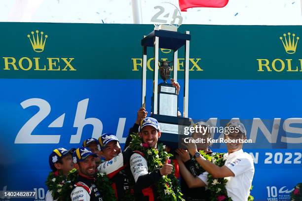 The Toyota Gazoo Racing GR010 Hybrid team of Sebastien Buemi, Brendon Hartley, Ryo Hirakawa, get help lifting the trophy with second placed team...