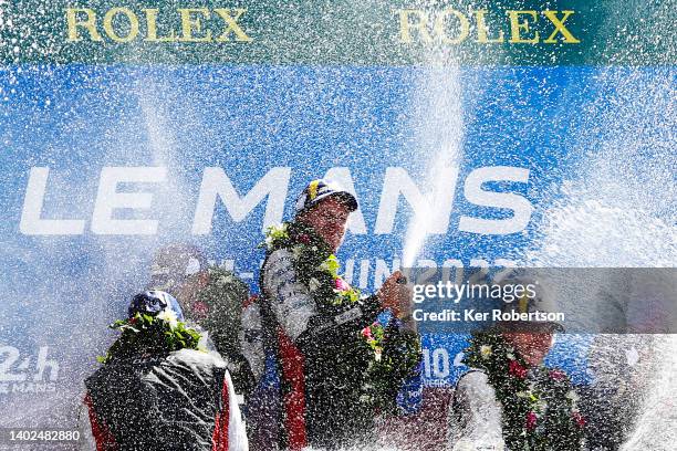 The Toyota Gazoo Racing GR010 Hybrid driver Brendon Hartley of New Zealand celebrates with team mates Sebastien Buemi and Ryo Hirakawa on the podium...