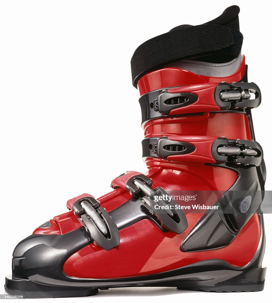 A profile of a single modern red ski boot