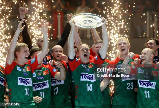 Omar Magnusson of SC Magdeburg lifts the trophy after winning the german handball championship after the LIQUI MOLY HBL match between SC Magdeburg...