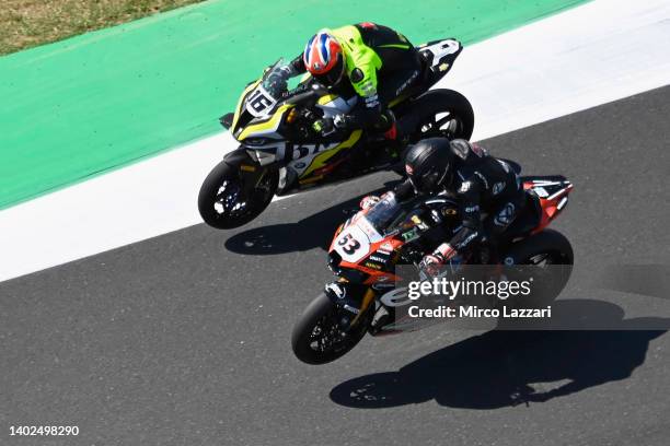 Leandro Mercado of Argentina and Mie Racing Honda Racing and Tito Rabat of Spain and Kawasaki Puccetti Racing lift the front wheel during the FIM...