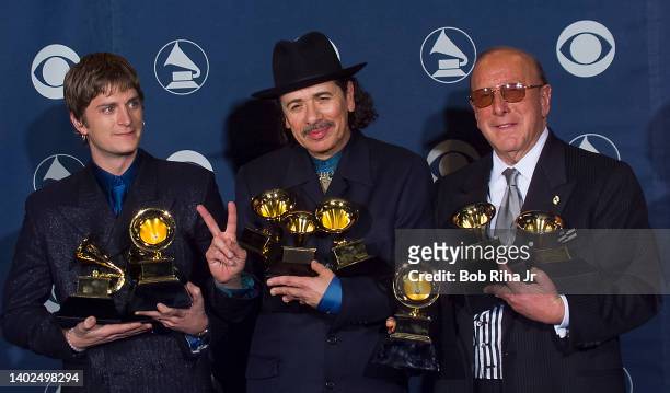 Multi-Grammy Winner Carlos Santana is joined by Rob Thomas and Clive Davis backstage at the Grammy Awards Show, February 23, 2000 in Los Angeles,...