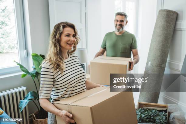 mature couple with moving boxes in new home - physical activity stock pictures, royalty-free photos & images