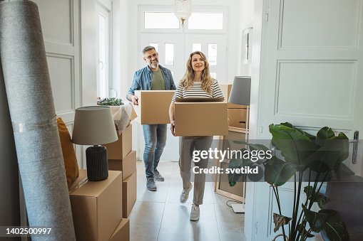 Mature Couple with Moving Boxes in New Home Mature Couple with Moving Boxes in New Home