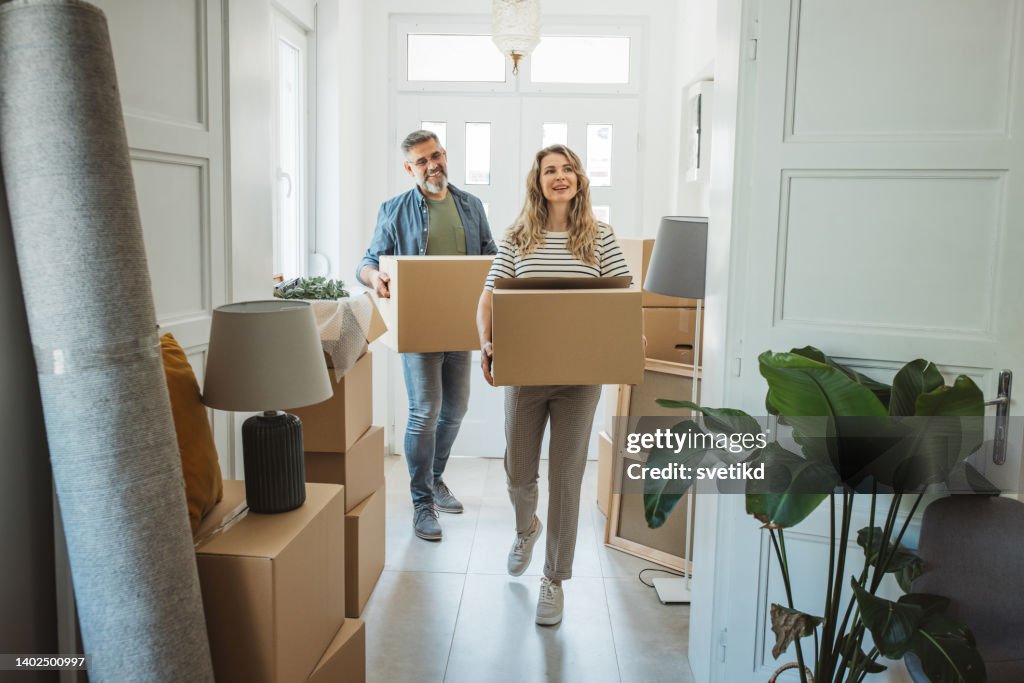 Mature Couple with Moving Boxes in New Home