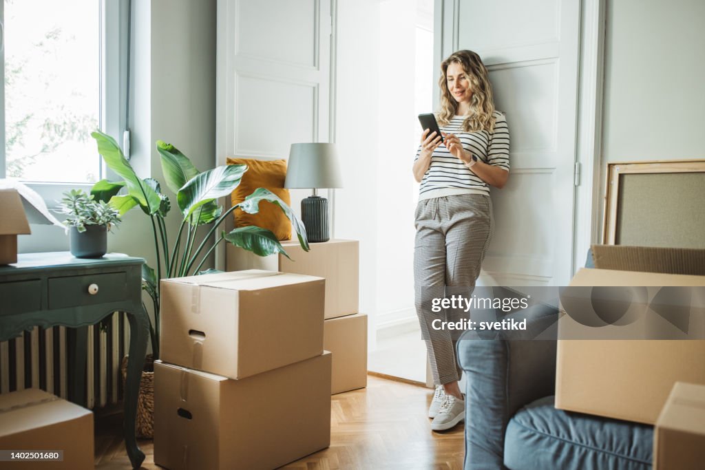 Mature woman with Moving Boxes in New Home