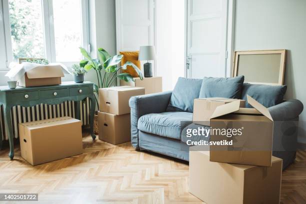 moving day concept, cardboard boxes in modern house. - moving in stock pictures, royalty-free photos & images