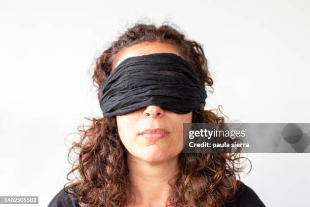 woman with handkerchief covering her eyes - eye bandage stock pictures, royalty-free photos & images