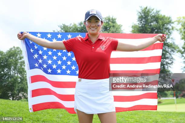 Rose Zhang of Team USA poses with her national flag after winning her point on the way to victory in The Curtis Cup at Merion Golf Club on June 12,...