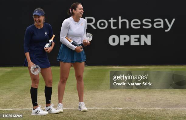 Caroline Dolehide of United States and Monica Niculescu of Romania with the women's doubles runners up trophy during day nine of the Rothesay Open at...