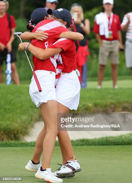 Rose Zhang and Rachel Kuehn of Team USA embrace on the 17th green after securing the points to win The Curtis Cup at Merion Golf Club on June 12,...