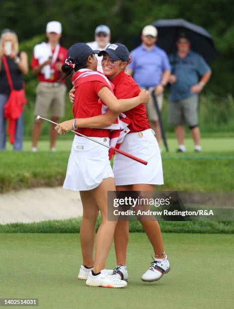 Rose Zhang and Rachel Kuehn of Team USA embrace on the 17th green after securing the points to win The Curtis Cup at Merion Golf Club on June 12,...